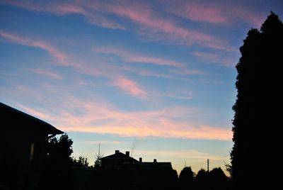 Low angle view of silhouette trees against sky at sunset