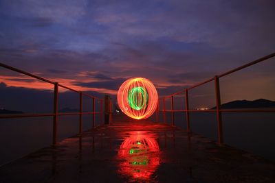 Light trails against sky at sunset