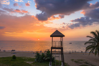 View of lifeguard hut at sea against sky during sunset