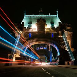 Illuminated bridge at night