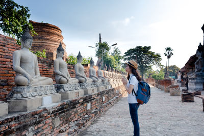 Statue in temple against sky