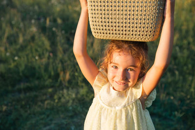 Portrait of girl with basket on head