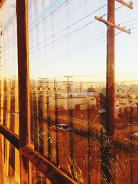 Buildings against sky seen through glass window
