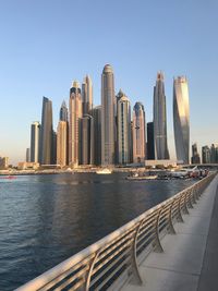 Modern buildings in city against clear sky