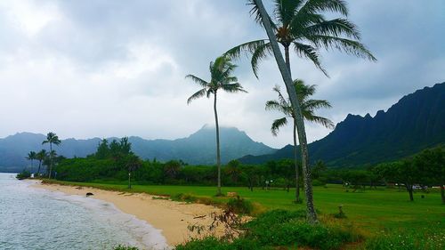 Scenic view of mountains against cloudy sky