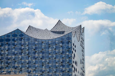 Low angle view of building against cloudy sky