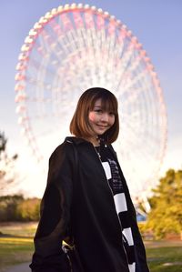 Portrait of a smiling young woman in amusement park