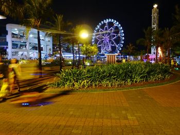 Illuminated ferris wheel at night