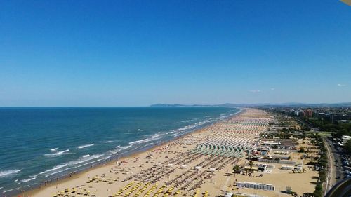 Scenic view of beach against blue sky