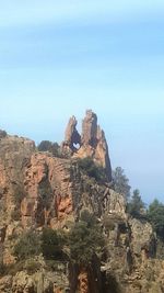 View of rock formations on landscape against sky