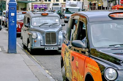 Cars parked on road in city