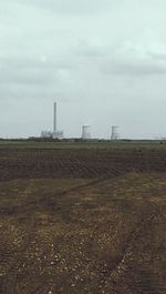 Built structure on landscape against cloudy sky