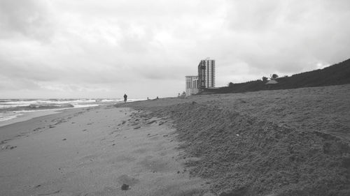 Scenic view of beach against sky in city