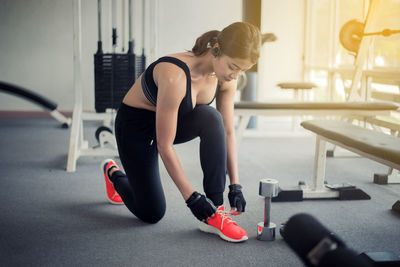 Full length of woman exercising at gym