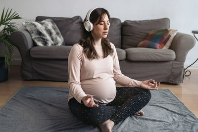 Woman sitting on sofa at home