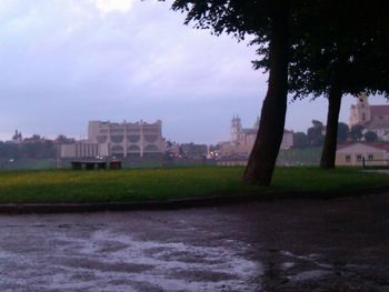 Buildings in city against cloudy sky