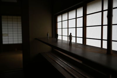 Silhouette people walking in glass window