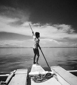 Full length of man standing by sea