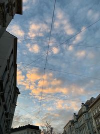 Low angle view of buildings against cloudy sky