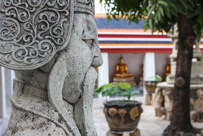 Statue of buddha against building