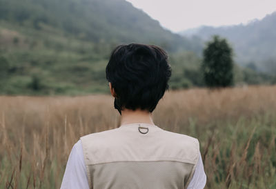 Rear view of man standing on field