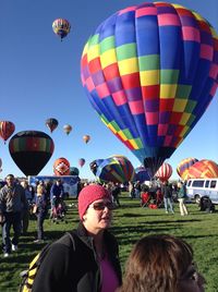 Woman against hot air balloons against sky