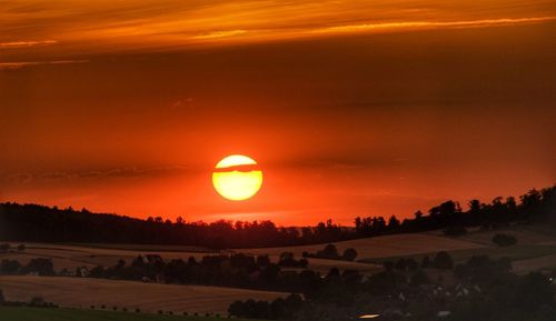 Scenic view of silhouette landscape against romantic sky at sunset