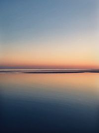 Scenic view of sea against clear sky during sunset