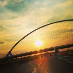 Bridge over river at sunset