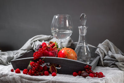 Fruits with wine in tray by fabric on table