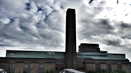 Low angle view of building against cloudy sky