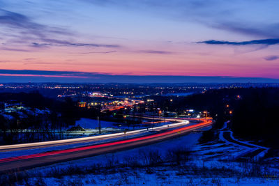 High angle view of light trails on road against sky at night