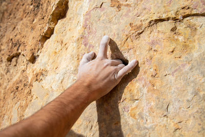 Midsection of man on rock