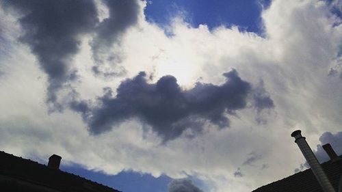 Low angle view of building against cloudy sky