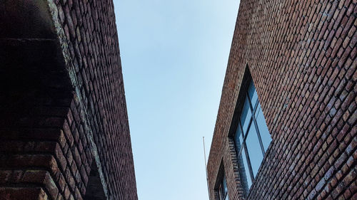 Low angle view of buildings against clear blue sky