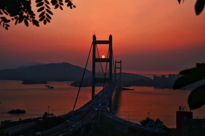 Suspension bridge against sky during sunset