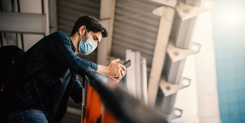 Side view of man using mobile phone