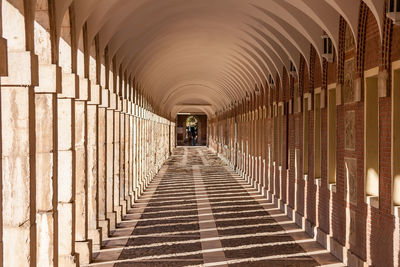 Rear view of man walking on corridor