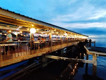 Bridge over river against sky at dusk