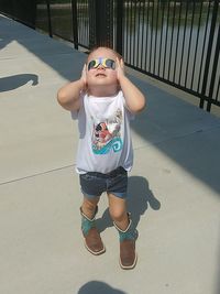 Full length of girl standing against wall