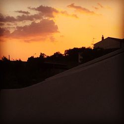 Silhouette of house at sunset