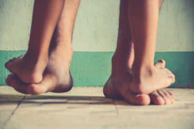 Low section of woman standing on footpath