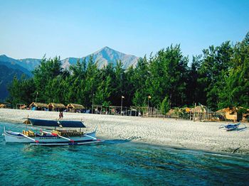 Scenic view of lake against clear blue sky