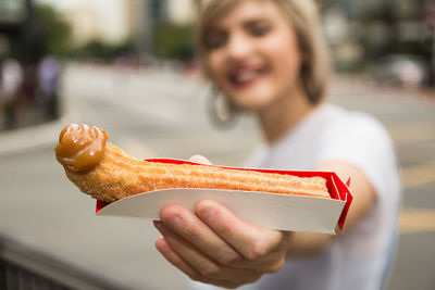 Portrait of woman holding ice cream