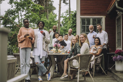 Portrait of multi-generation family during birthday celebration on porch