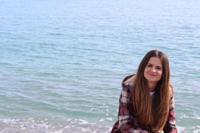 Portrait of a smiling young woman in sea