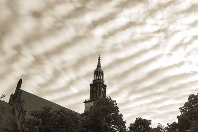 Low angle view of church against cloudy sky