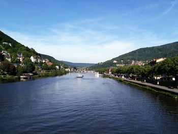 Scenic view of river and mountains against sky