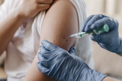 Midsection of doctor examining patient at clinic