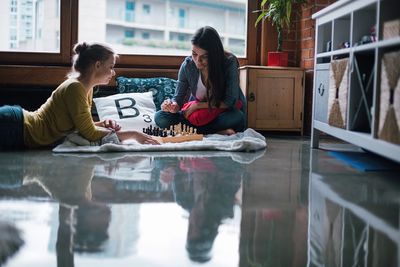 Women sitting on table at home